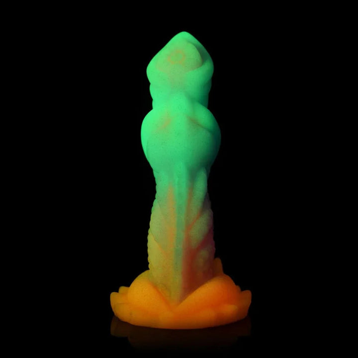 Aqua-Cock dildo photographed in the dark, glowing green and yellow