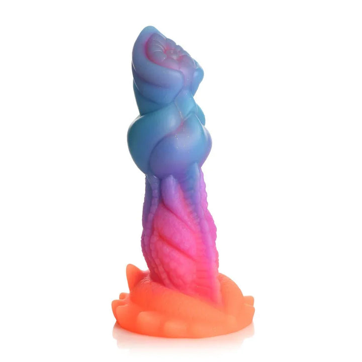 Aqua-Cock dildo upright on white, blue head over a pink twisted shaft and orange coral base