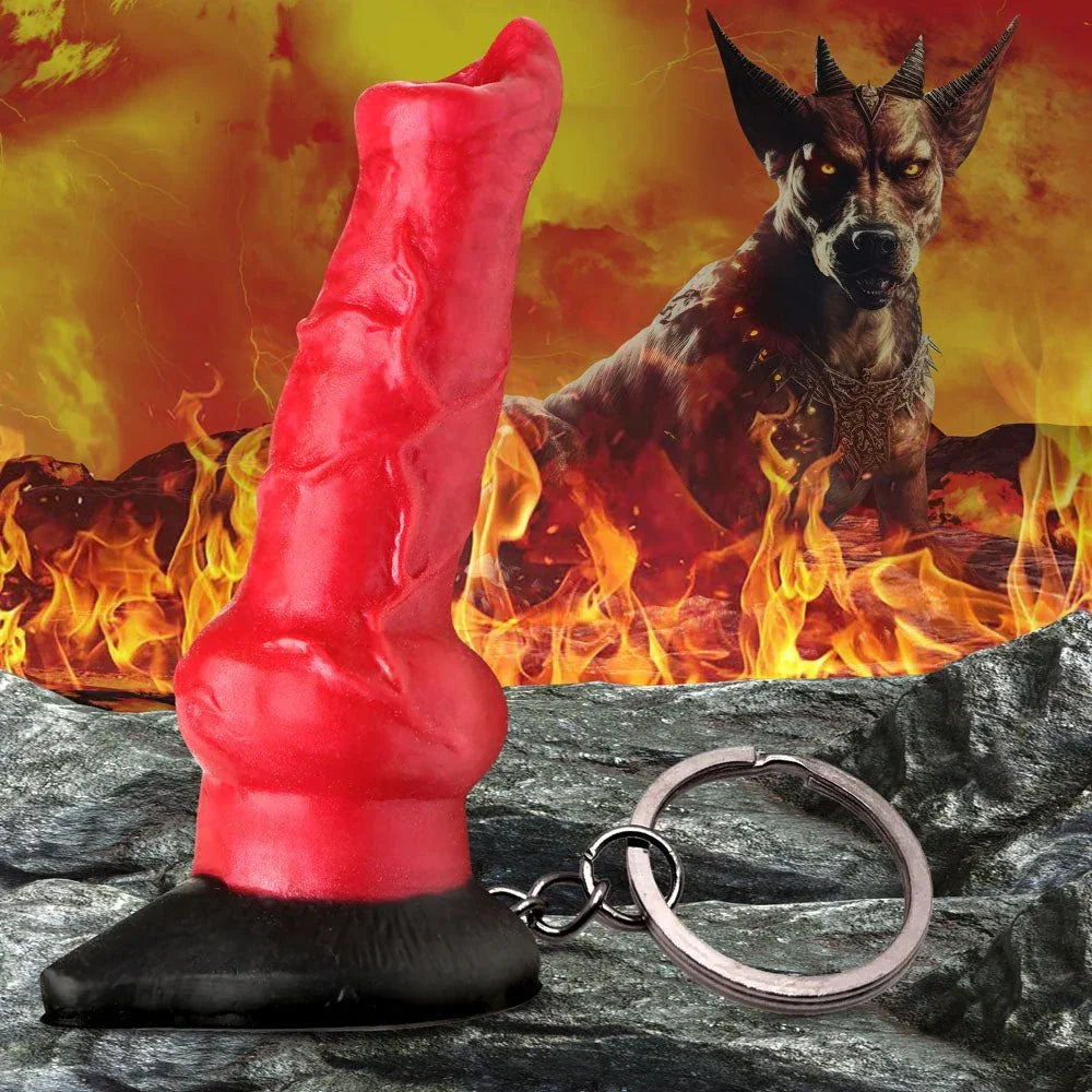 Hell Hound keychain standing on its black base against flames, red canine sculpt