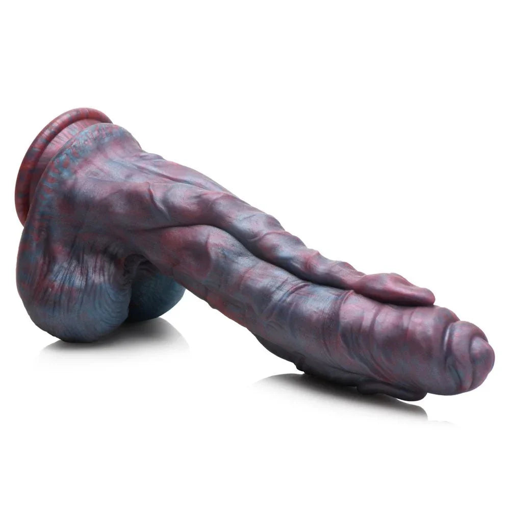 Hydra dildo lying on white at an angle, showing the veined underside and the ball base