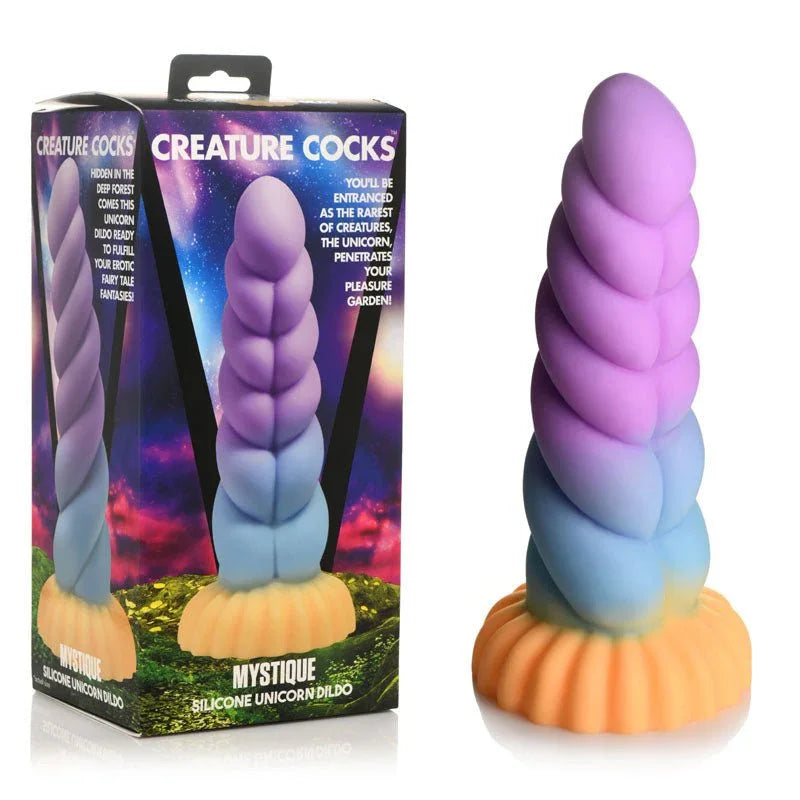 Creature Cocks Mystique unicorn dildo, twisted purple horn on an orange base, beside its box