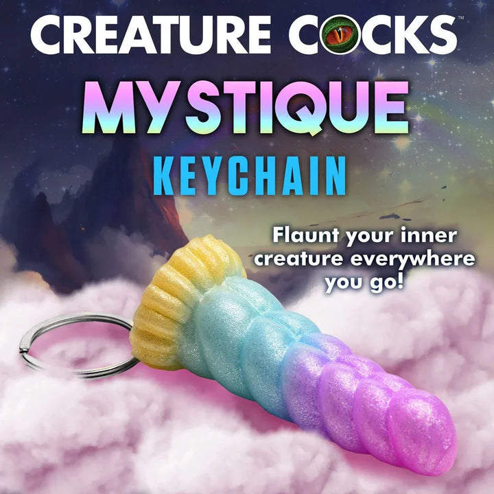 Mystique Keychain title panel, the rainbow keyring lying on cloud artwork