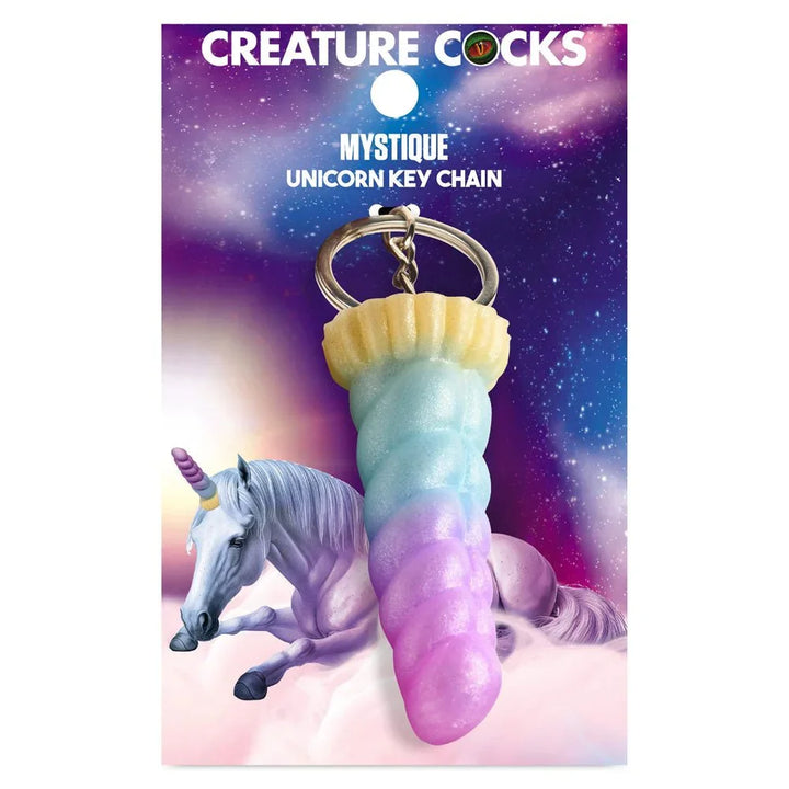 Creature Cocks Mystique unicorn keychain on its printed backer card