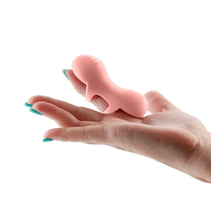 Desire Fingerella finger stimulator in Pink worn over two fingers of an open hand