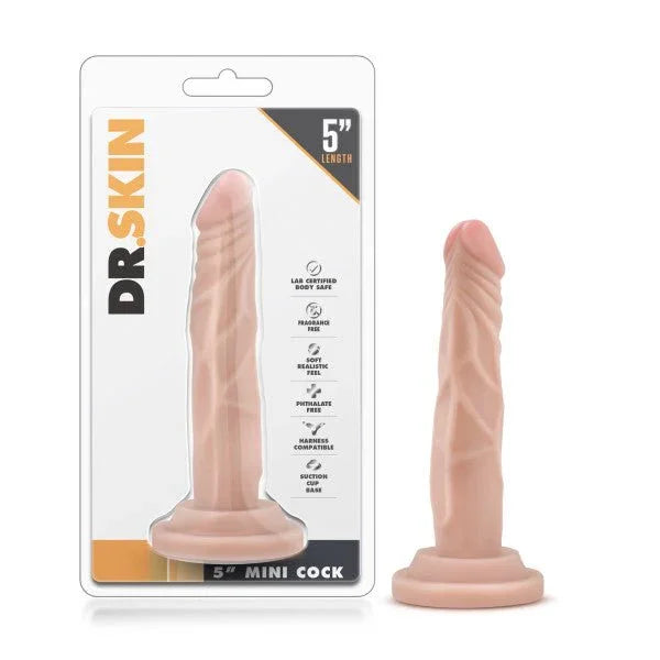 Dr. Skin 5 inch Mini Cock in flesh tone with suction base, beside its blister pack