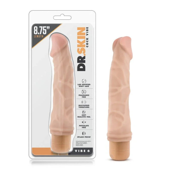 Dr. Skin Cock Vibe 6 vibrating dong in flesh tone beside its 8.75 inch blister pack