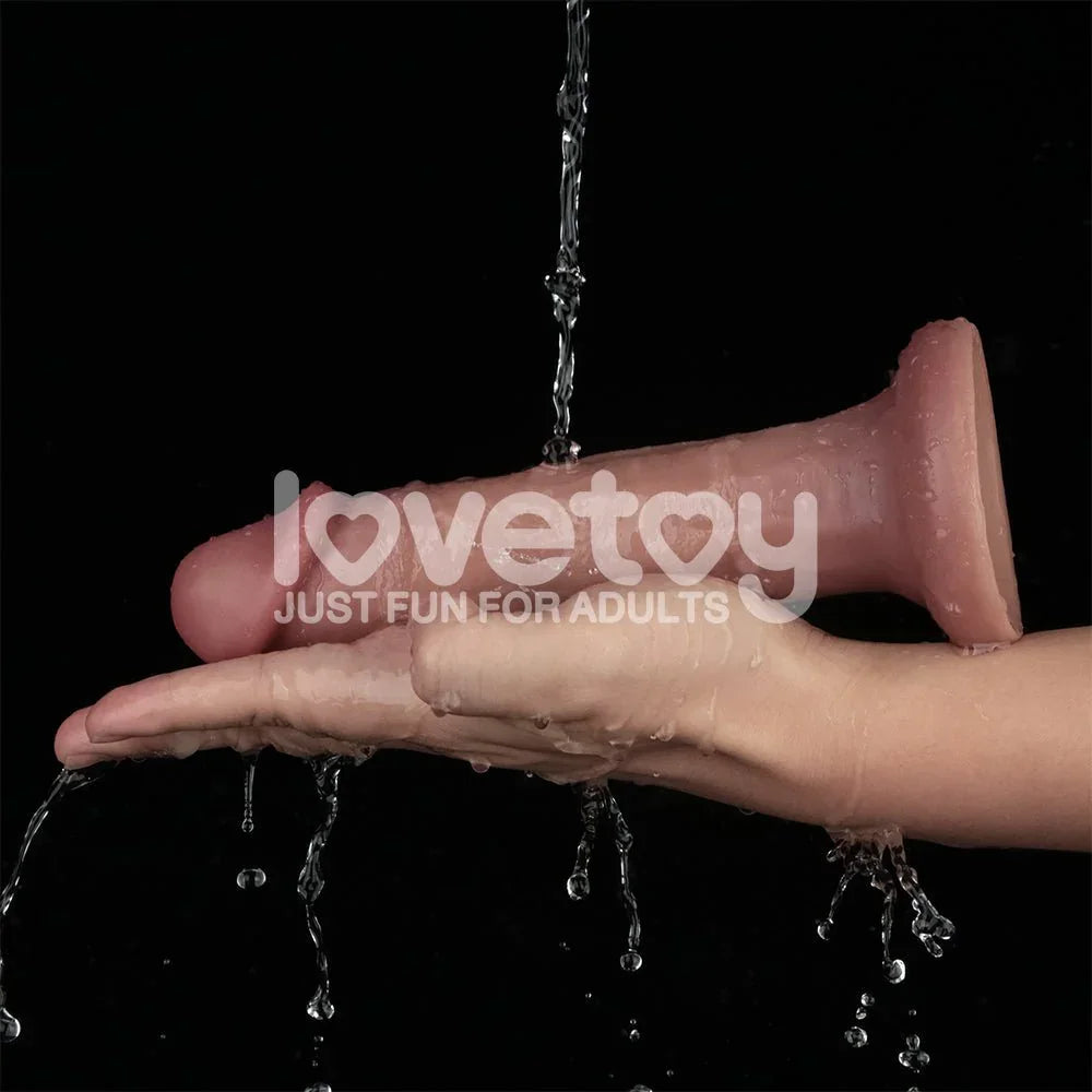 Dual Density Power Cock 8 inch held under running water over a hand, demonstrating waterproofing