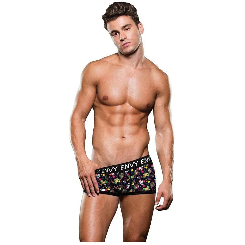 Male model wearing the Envy Disco Unicorn trunks, black with a multi-colour print