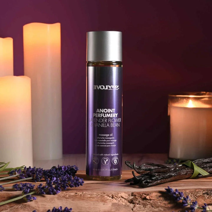 Evolved Anoint Perfumery Lavender Flower & Vanilla Bean oil, purple bottle upright among lit candles