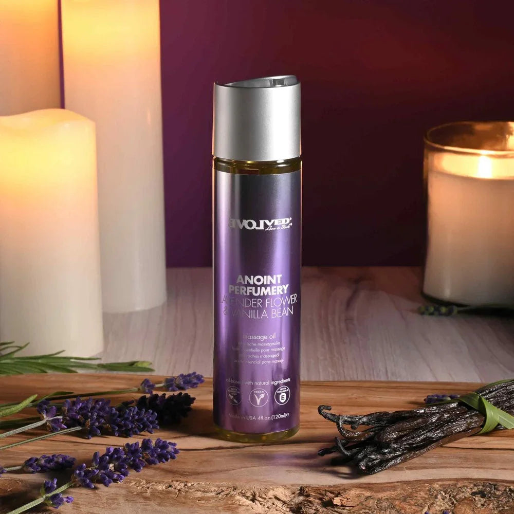 Evolved Anoint Lavender Flower & Vanilla Bean oil bottle on bark, lavender sprigs and vanilla pods