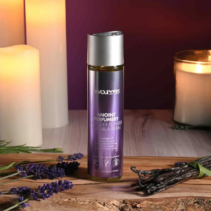 Evolved Anoint Lavender Flower & Vanilla Bean oil bottle on bark, lavender sprigs and vanilla pods