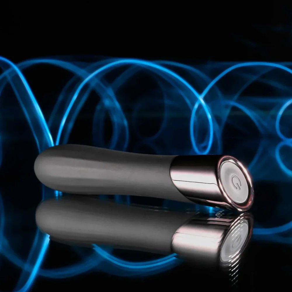Evolved Back In Black bullet in Black lying on a reflective surface, chrome cap and power button showing