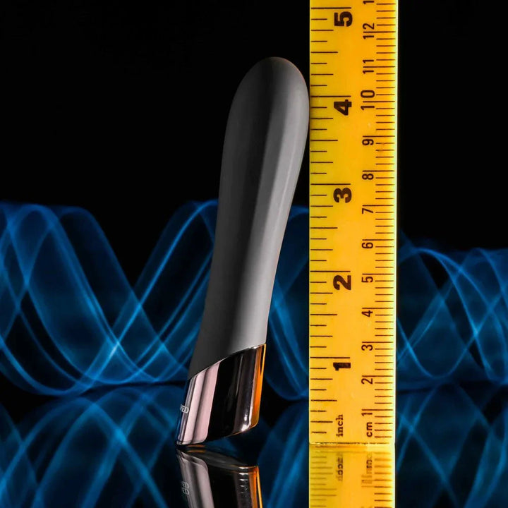 Evolved Back In Black bullet in Black stood against a tape measure, reading about 4.5 inches