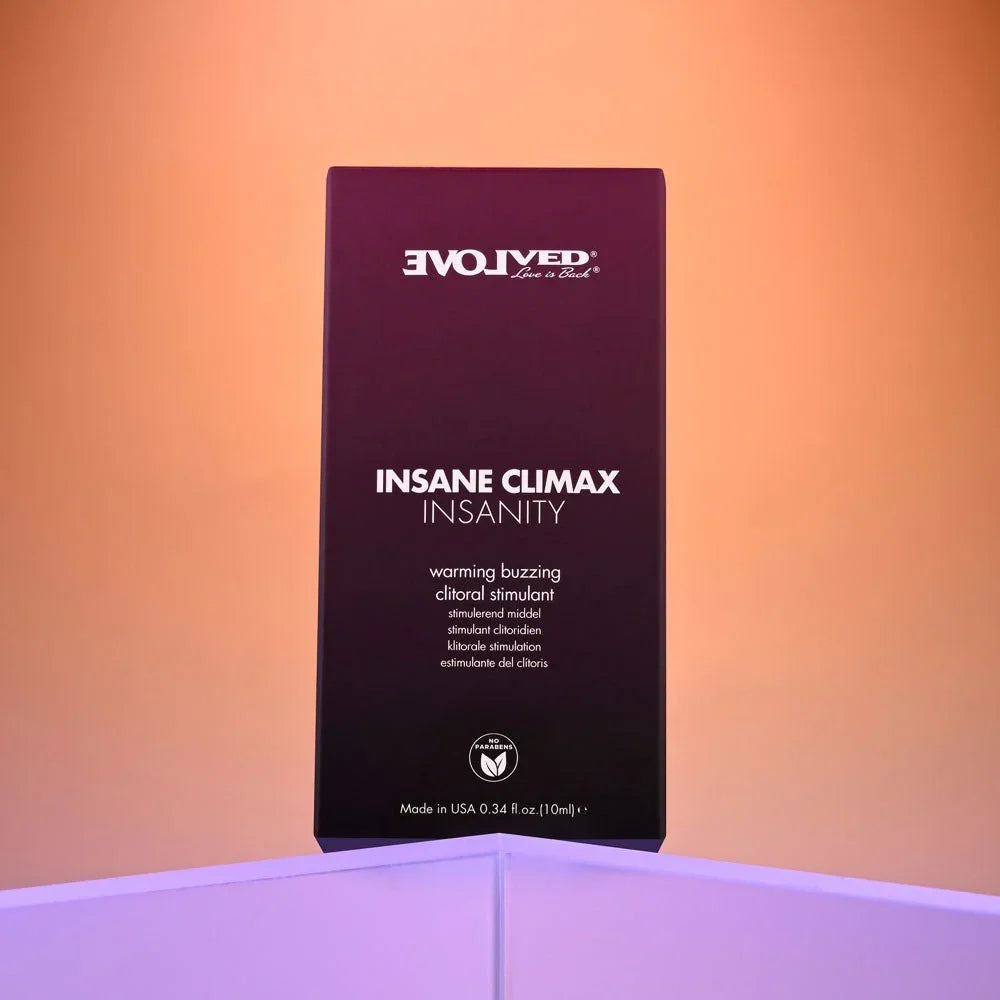 Evolved Insane Climax Insanity carton alone, front panel facing the camera on a lilac ledge