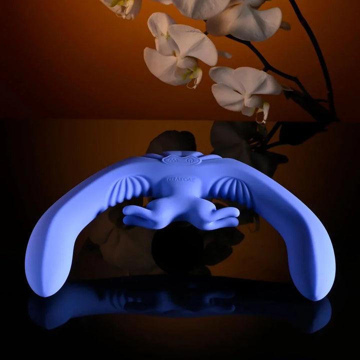 Evolved Lovebirds in periwinkle laid low on a reflective surface, side profile of both ends