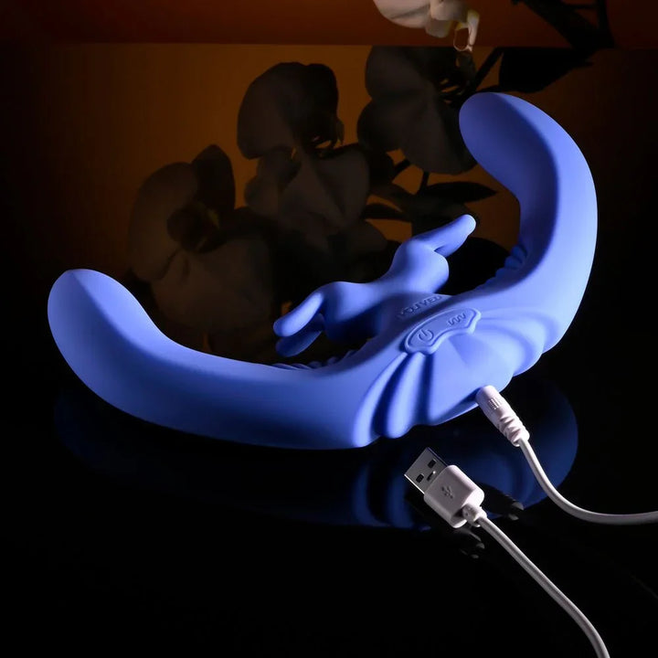 Evolved Lovebirds in periwinkle with its USB charging cable plugged into the base
