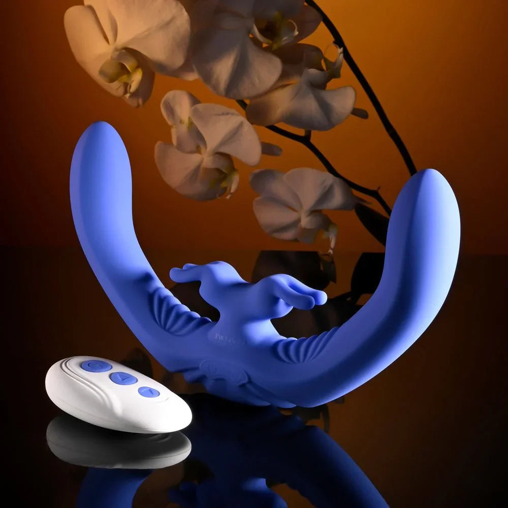 Evolved Lovebirds in periwinkle standing curved on a dark reflective surface, white remote at the left
