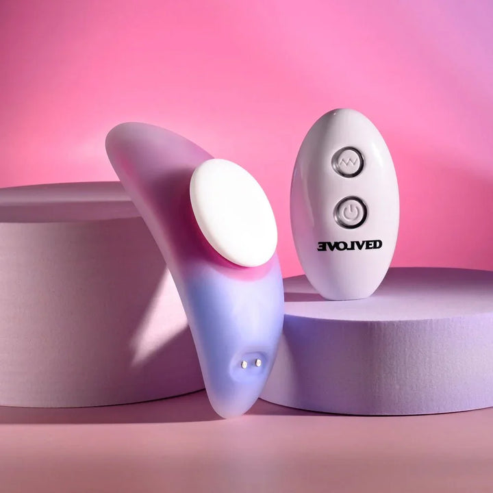 Evolved Paradise Panty in Pink/Purple leaning on a podium, white magnet disc facing out, remote at right