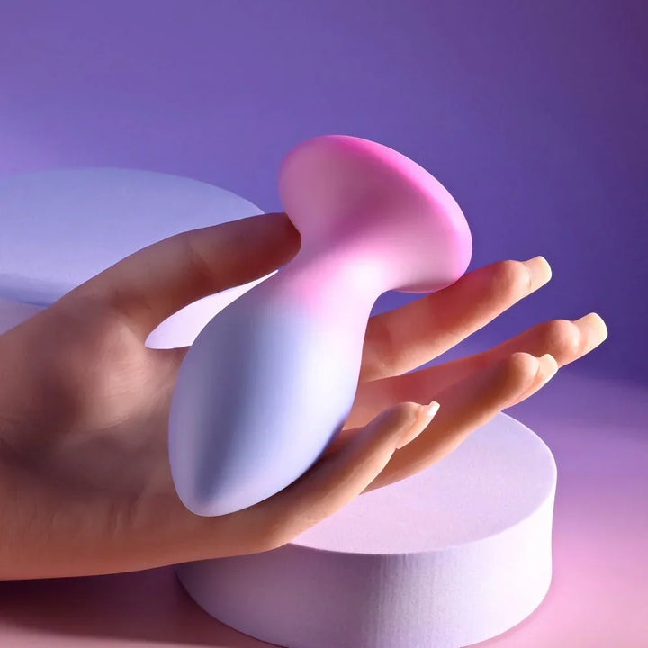 Evolved Paradise Plug in Pink/Purple held in a hand for scale, base across the palm