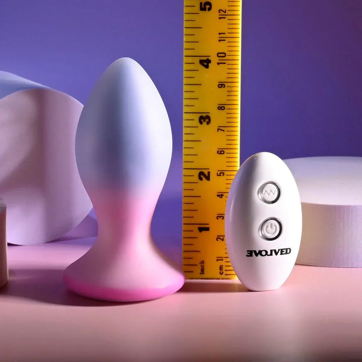 Evolved Paradise Plug in Pink/Purple upright beside a tape measure, reading about 3.5 inches