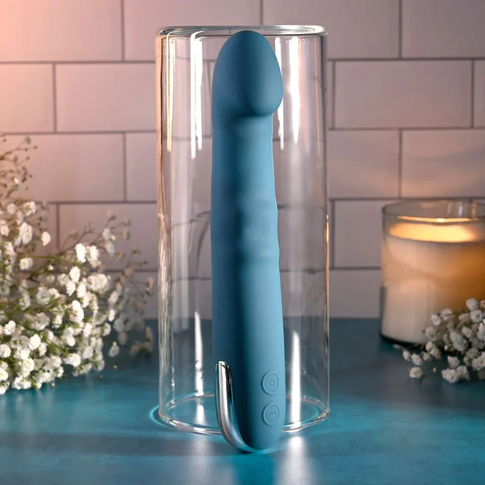 Evolved Queen Of All Trades in teal blue standing upright inside a clear glass cylinder