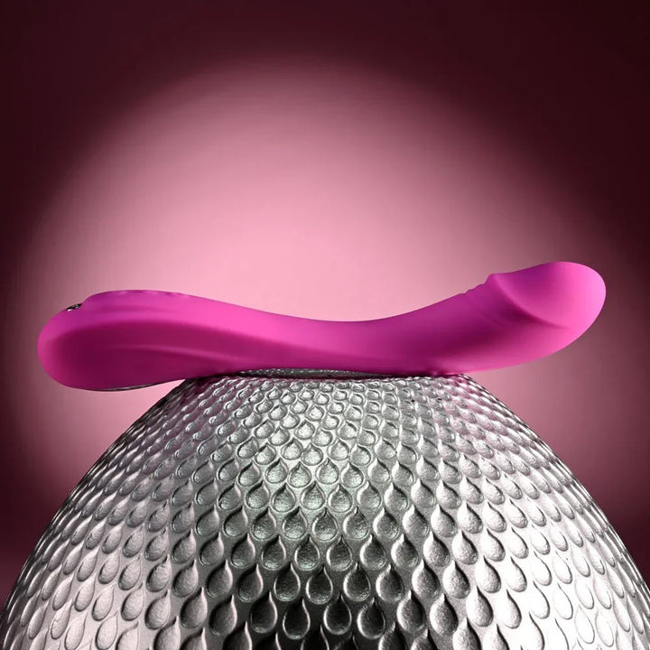 Evolved Sugar Rush in Pink balanced horizontally across the top of the silver sphere