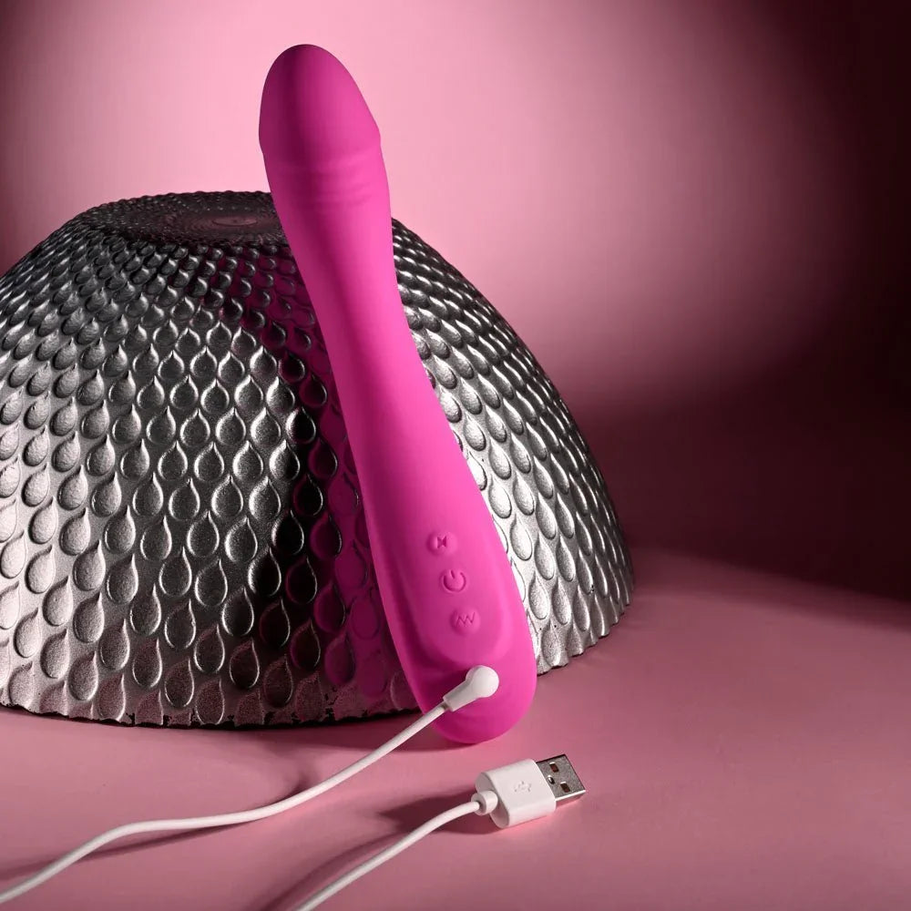 Evolved Sugar Rush in Pink resting on the silver sphere with its USB charging cable attached