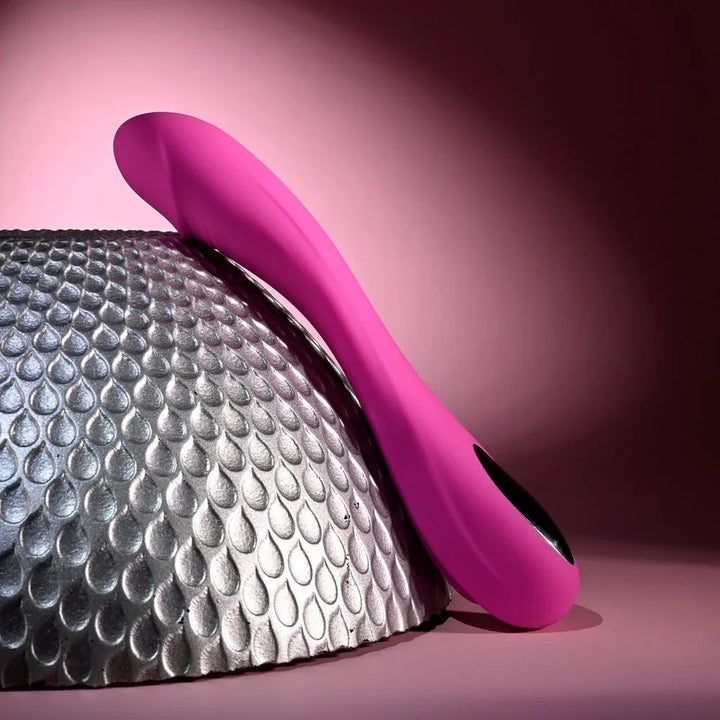 Evolved Sugar Rush in Pink leaning low across the silver sphere, showing the full S-curve