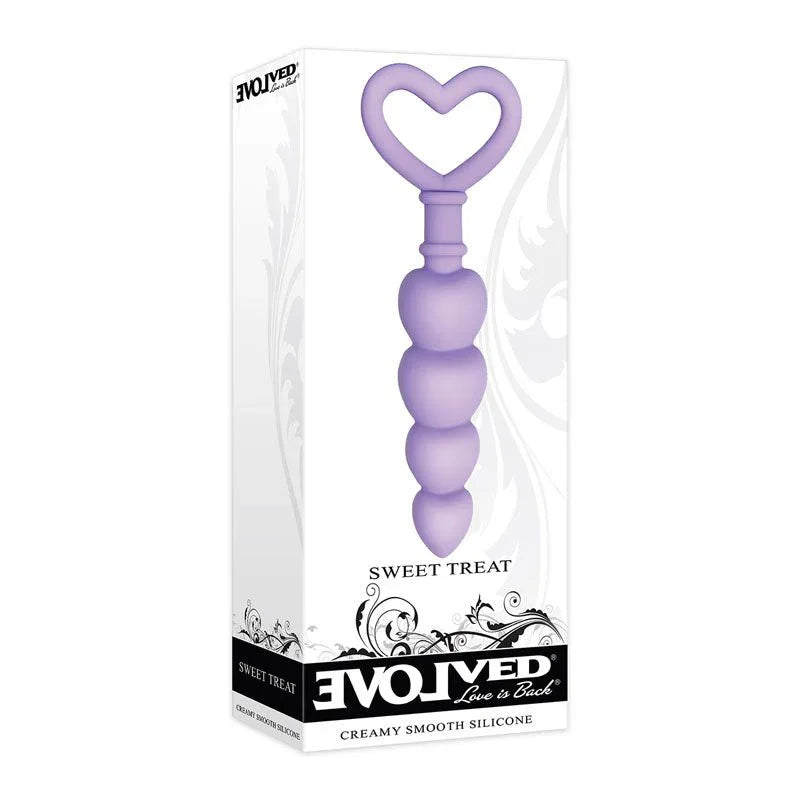 Evolved Sweet Treat butt plug in Purple standing in front of its retail box, overlapping the pack