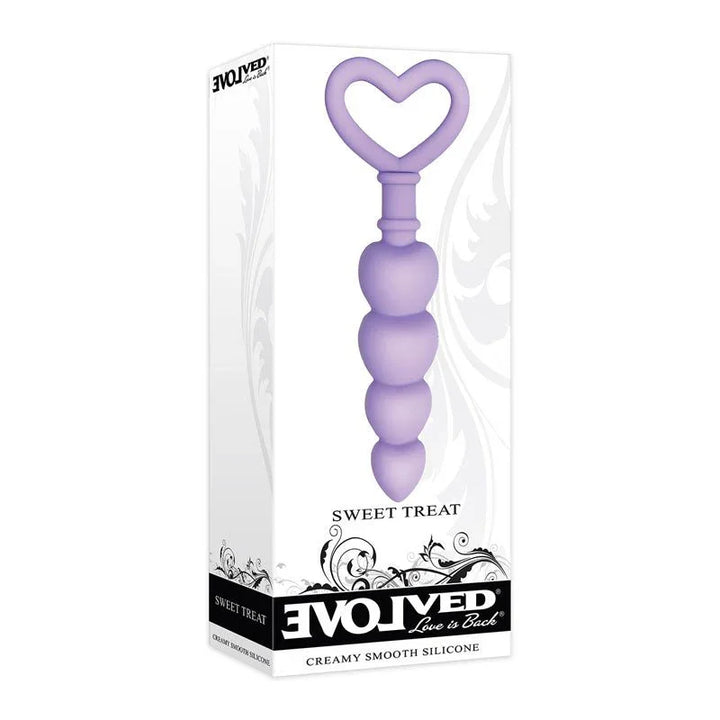 Evolved Sweet Treat butt plug in Purple standing in front of its retail box, overlapping the pack