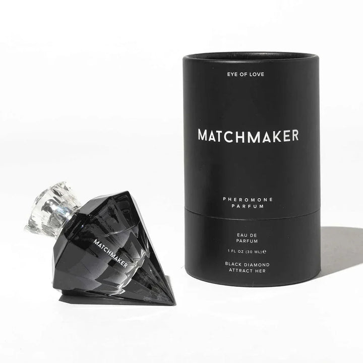 Matchmaker Black Diamond bottle lying on its side next to its black cylinder tube