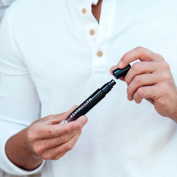 Eye Of Love Matchmaker Black Diamond All Cologne 10ml being uncapped by a man in a white henley