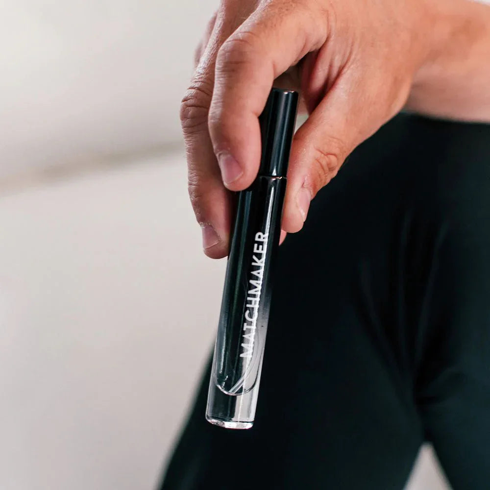 Man holding the black Matchmaker Black Diamond vial from the Couples Kit