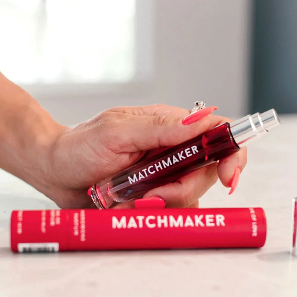 Eye Of Love Matchmaker Red Diamond Parfum 10ml held in a hand beside its red carton