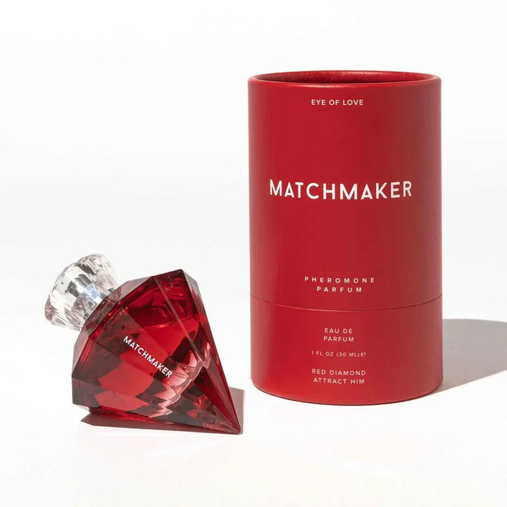 Matchmaker Red Diamond bottle lying on its side next to its red cylinder tube