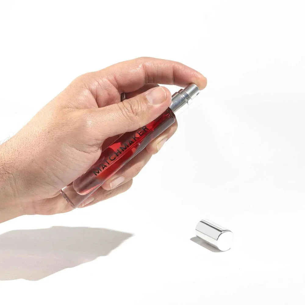 Eye Of Love Matchmaker Red Diamond LGBTQ Parfum 10ml held in a hand, silver cap alongside