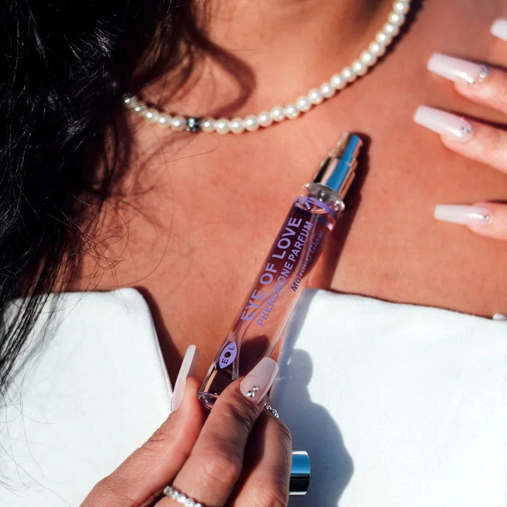 Close-up of Morning Glow 10ml being applied at a pearl necklace and bare shoulder