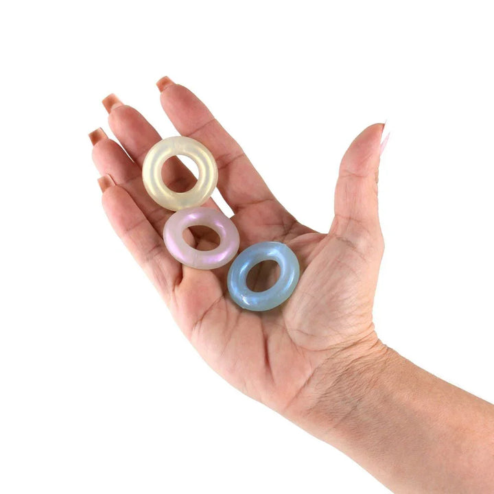 Fantasia Stamina Rings in pearl, blue and yellow held in an open palm