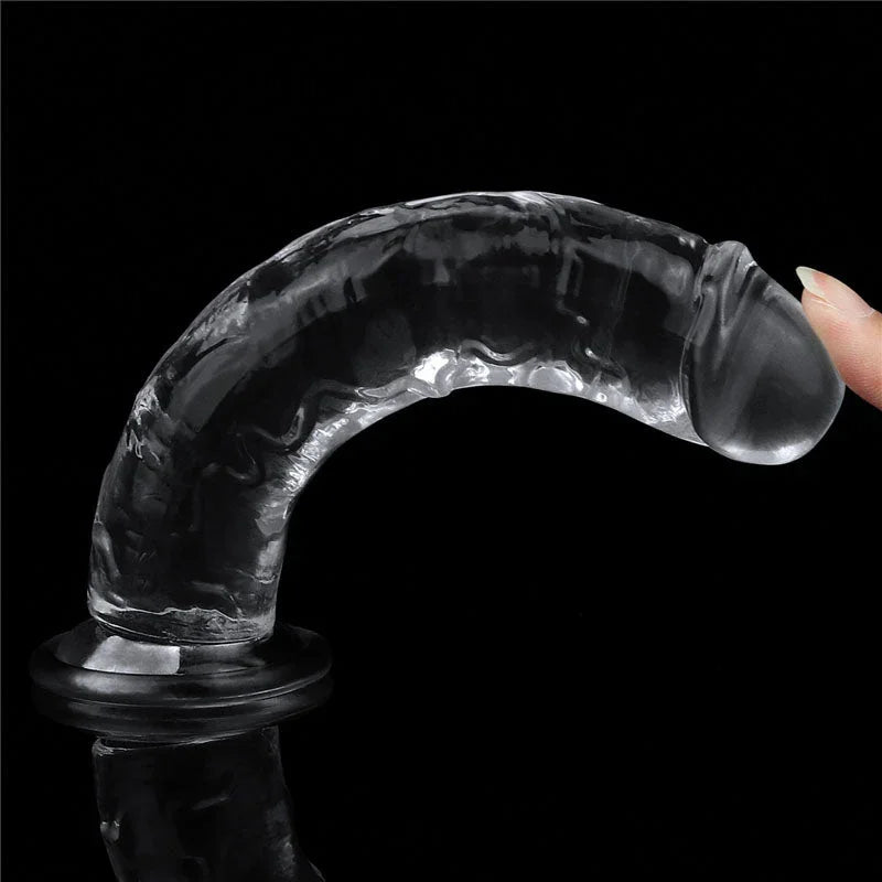 Flawless Clear 7 inch dildo bent over on its base by a fingertip, showing the flex