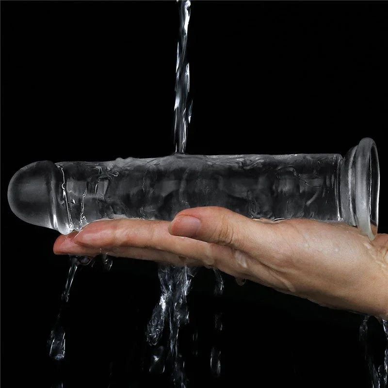 Flawless Clear 7 inch dildo rinsed under running water over a hand