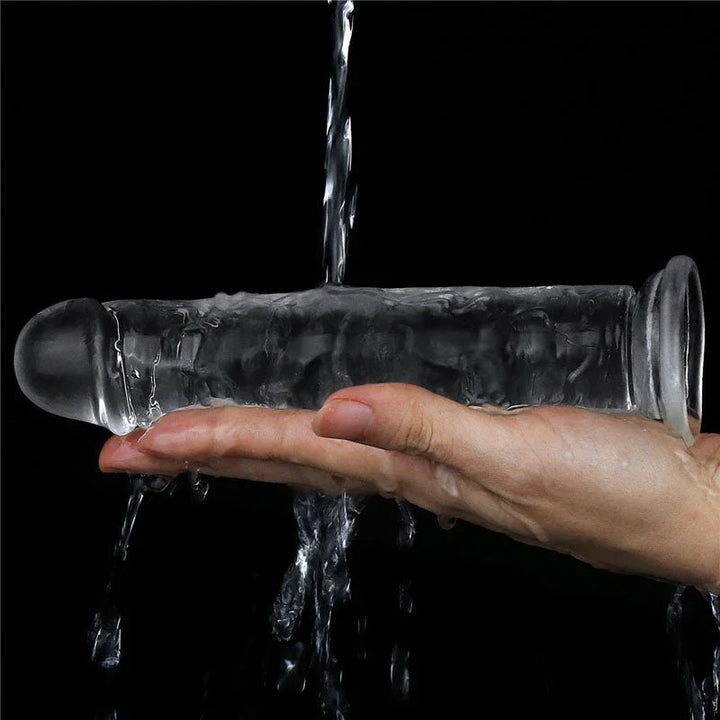 Flawless Clear 7 inch dildo rinsed under running water over a hand