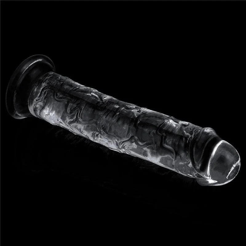 Flawless Clear 7 inch dildo lying at an angle on black, suction base to the left