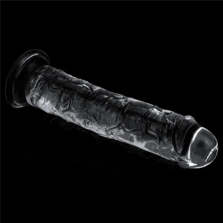 Flawless Clear 7 inch dildo lying at an angle on black, suction base to the left