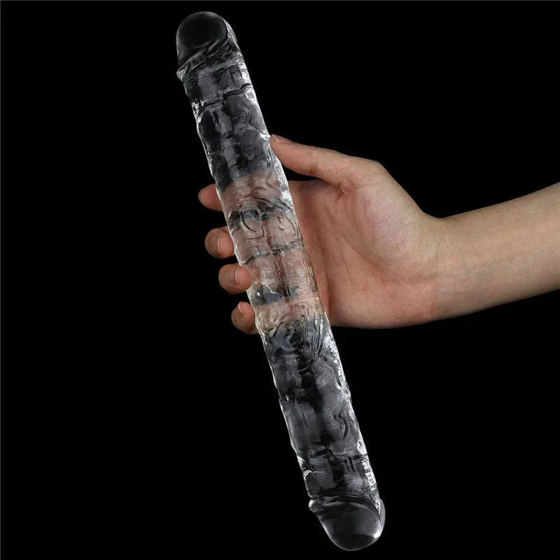 Hand holding the Flawless Clear double dildo upright at its middle for scale