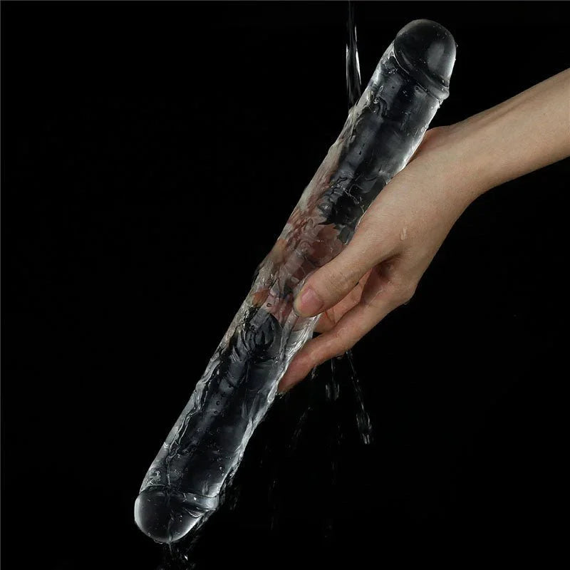 Flawless Clear double dildo rinsed under running water across a hand
