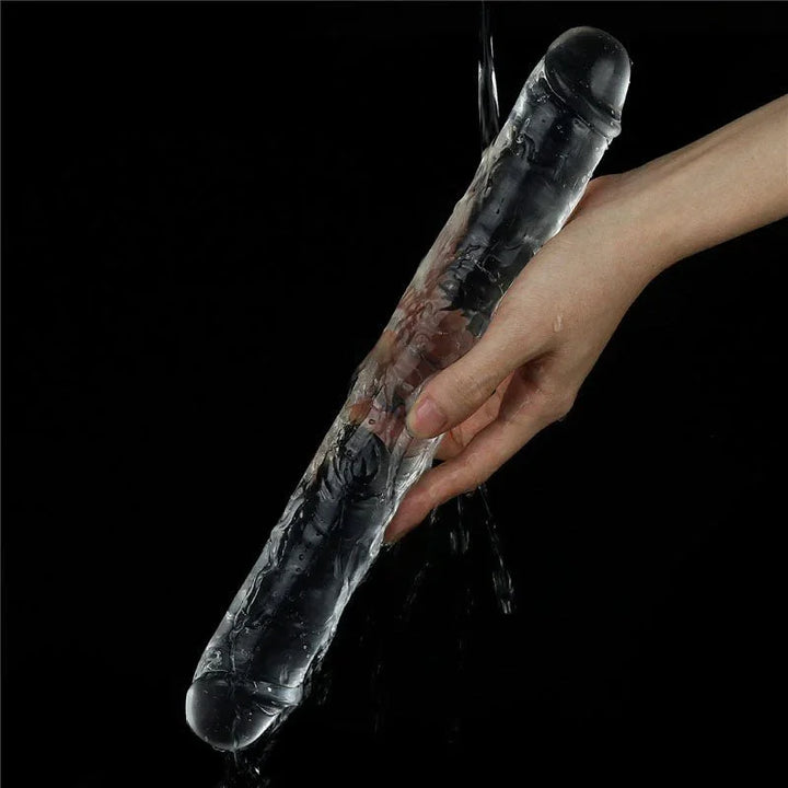 Flawless Clear double dildo rinsed under running water across a hand