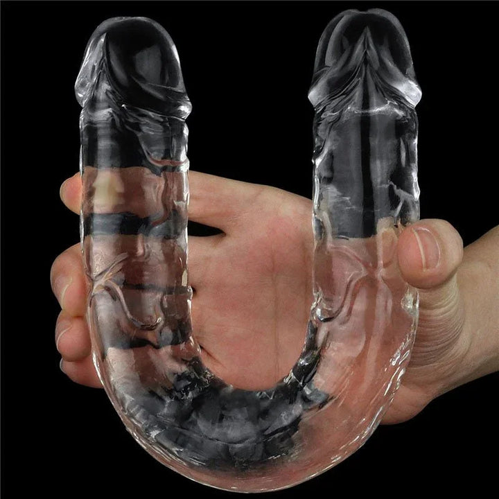 Flawless Clear double dildo bent into a U in one hand, both heads pointing up