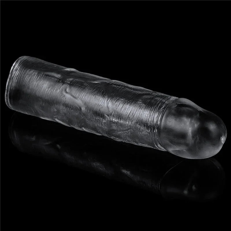 Flawless Clear sleeve lying at an angle on black, closed rounded tip toward the camera