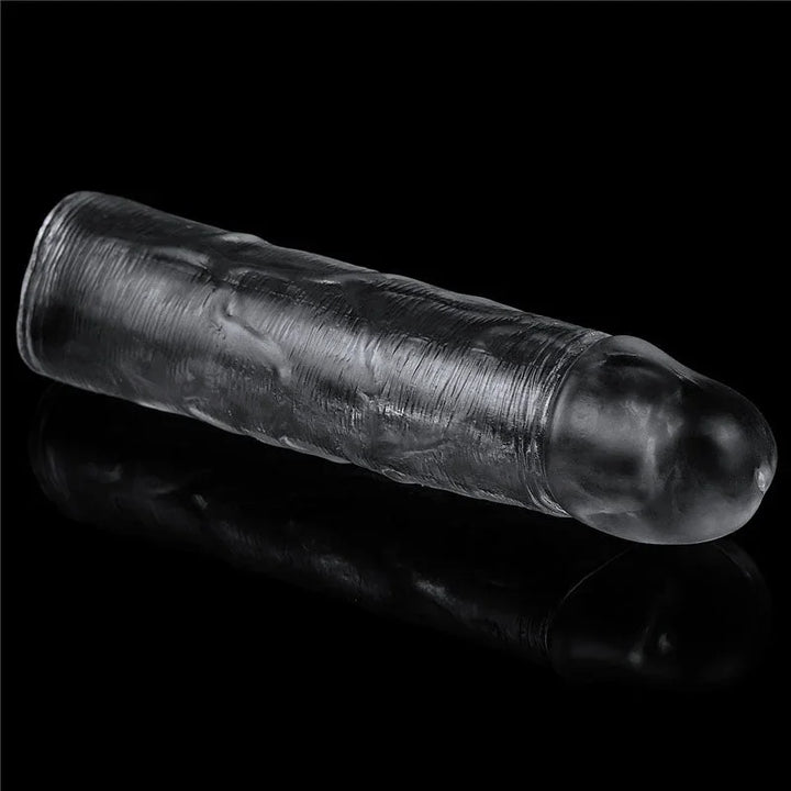 Flawless Clear sleeve lying at an angle on black, closed rounded tip toward the camera