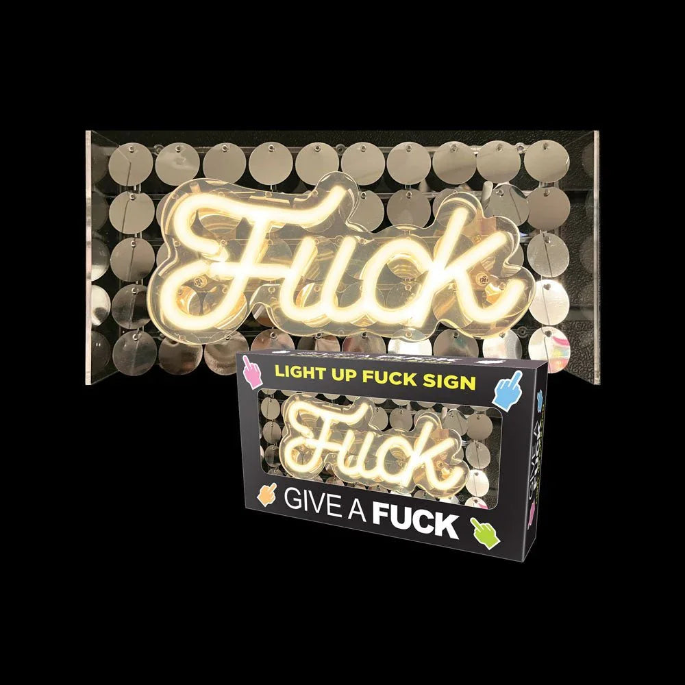 Fuck LED neon sign lit on a gold disc backing, shown beside its retail box